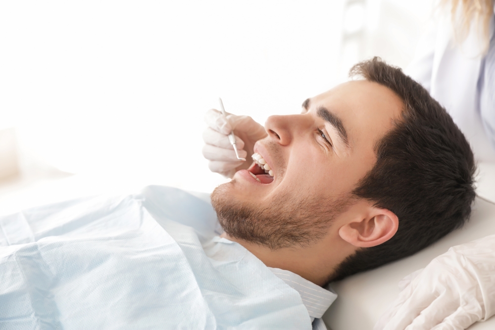 Comfortable Cosmetic Dental Exam - Porcelain Veneers Orange County A patient receives a gentle dental evaluation as part of the porcelain veneer preparation process for a flawless smile - Porcelain Veneers Orange County