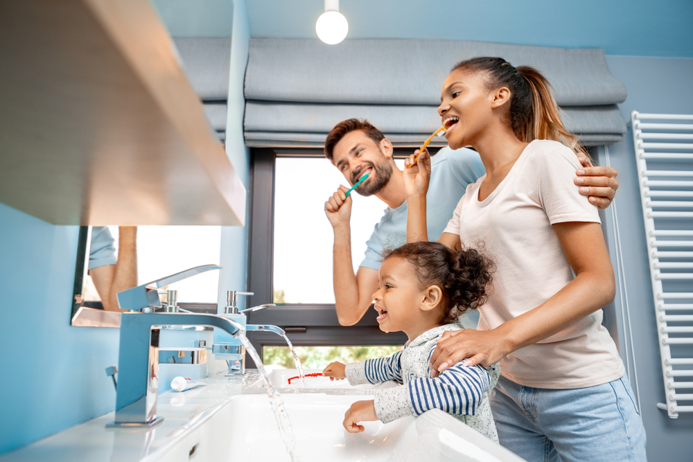 Family Oral Hygiene and Healthy Smiles – Invisalign Irvine A family brushing their teeth together at home to promote lifelong dental health – Invisalign Irvine