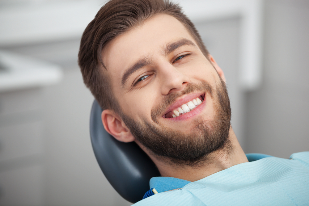 Natural Smile After Veneers - Porcelain Veneers Orange County A happy patient shows off a radiant smile after cosmetic dentistry treatment with porcelain veneers - Porcelain Veneers Orange County