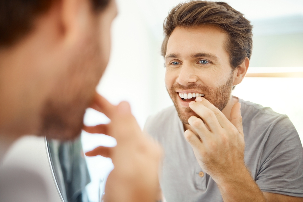 At-Home Smile Care Routine - Porcelain Veneers Orange County A woman practices daily oral hygiene to maintain long-lasting results after porcelain veneer treatment - Porcelain Veneers Orange County