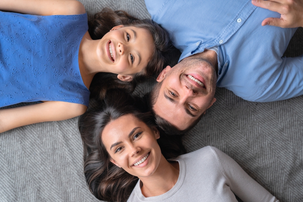 Confident Smile Portrait - Porcelain Veneers Orange County A close-up portrait of a woman with smooth, bright teeth after porcelain veneer cosmetic dentistry - Porcelain Veneers Orange County